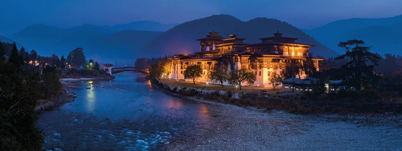 Dark view of a beautiful resort on the edge of a lake, and the mountains behind, Punaka Zhong, Bhutan