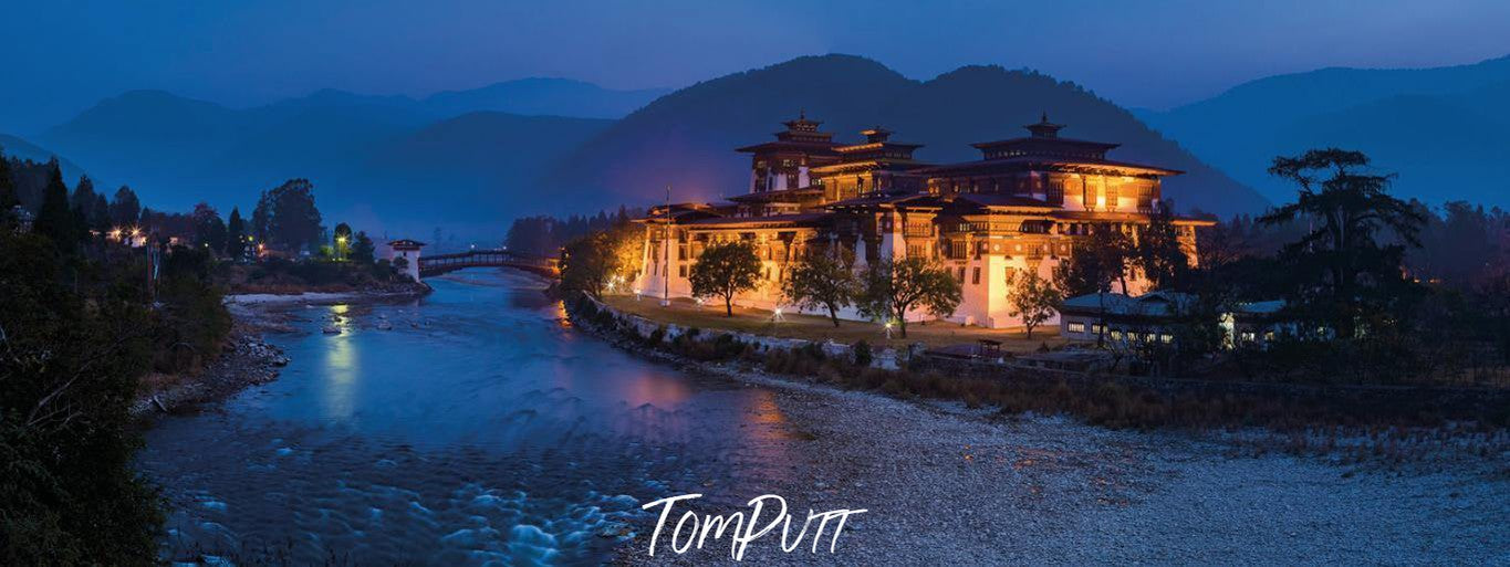 Dark view of a beautiful resort on the edge of a lake, and the mountains behind, Punaka Zhong, Bhutan