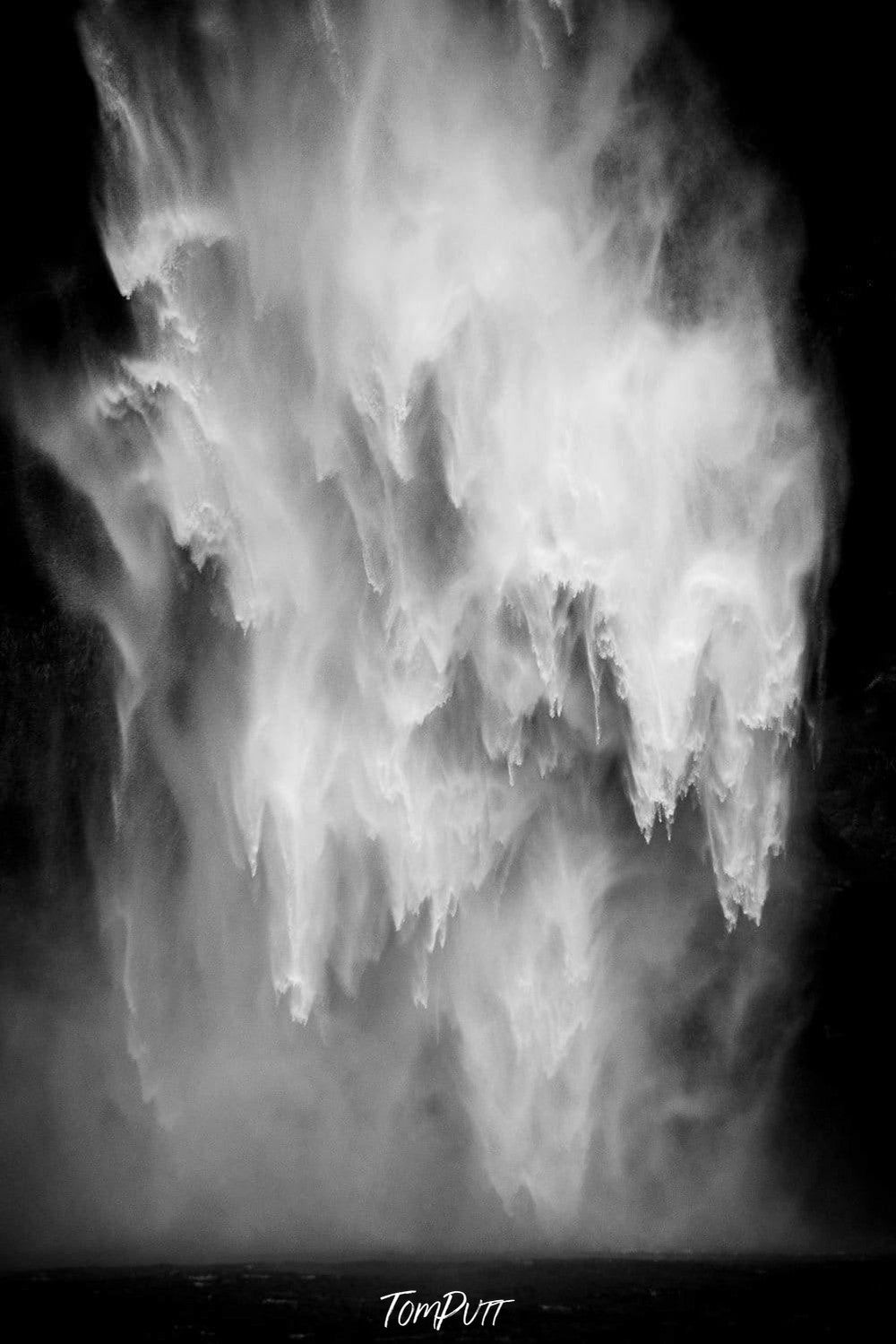 Massive waterfall with dark mountain wall bahind, Ragging Waterfall, Milford Sound - New Zealand