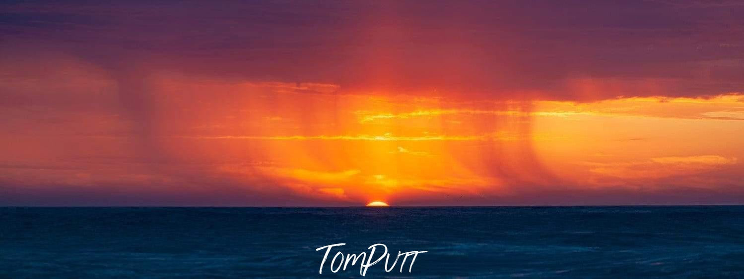 Heavy orange lines of the sunset and thick clouds, Rainset - Great Ocean Road VIC