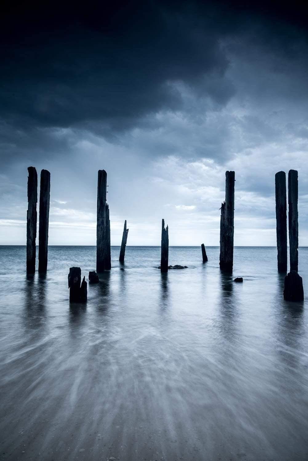 Wooden standing pillars on the beach, Randomness