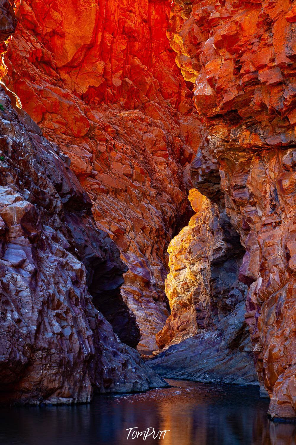 Red-bricked mountain walls with a small lake below, Redbank Gorge Pillar, West MacDonnell Ranges - Northern Territory  