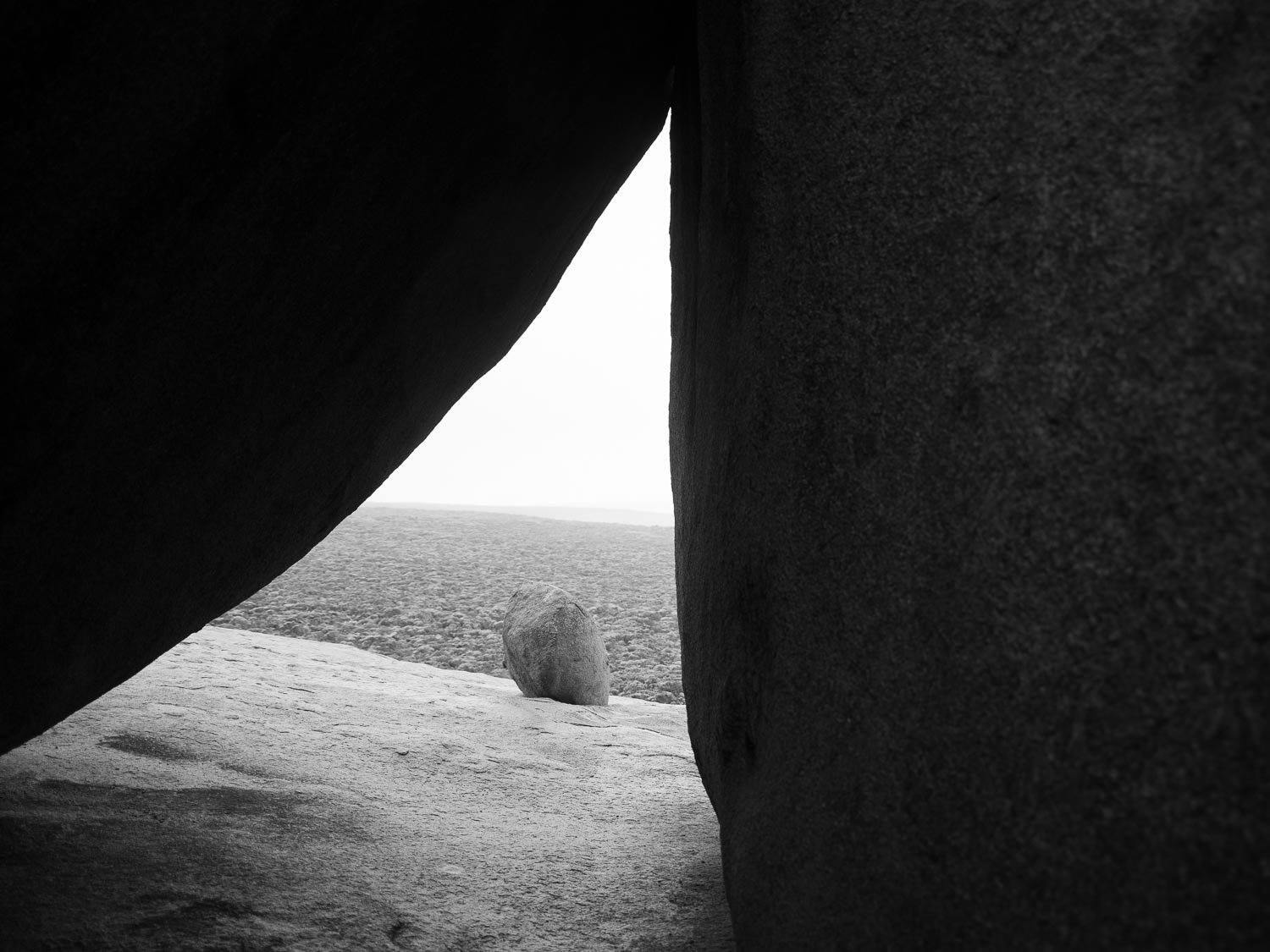Black and white view of a windowing shape between two large boulders, Remarkable Rocks #15 - Kangaroo Island SA