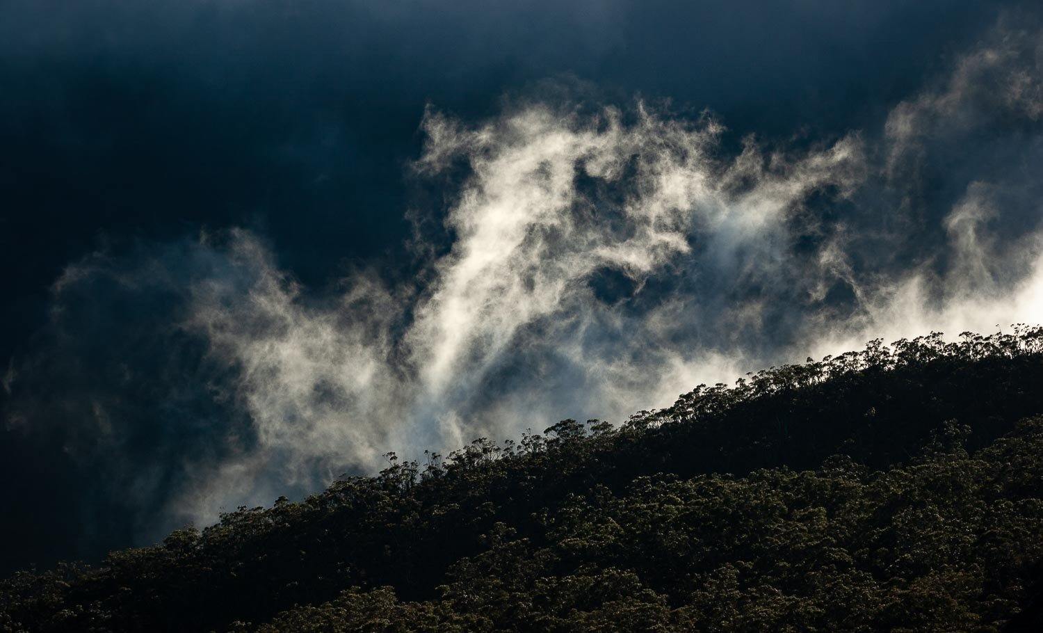 A large and dark green land with dark stormy clouds over, Rising Clouds - The Grampians, VIC