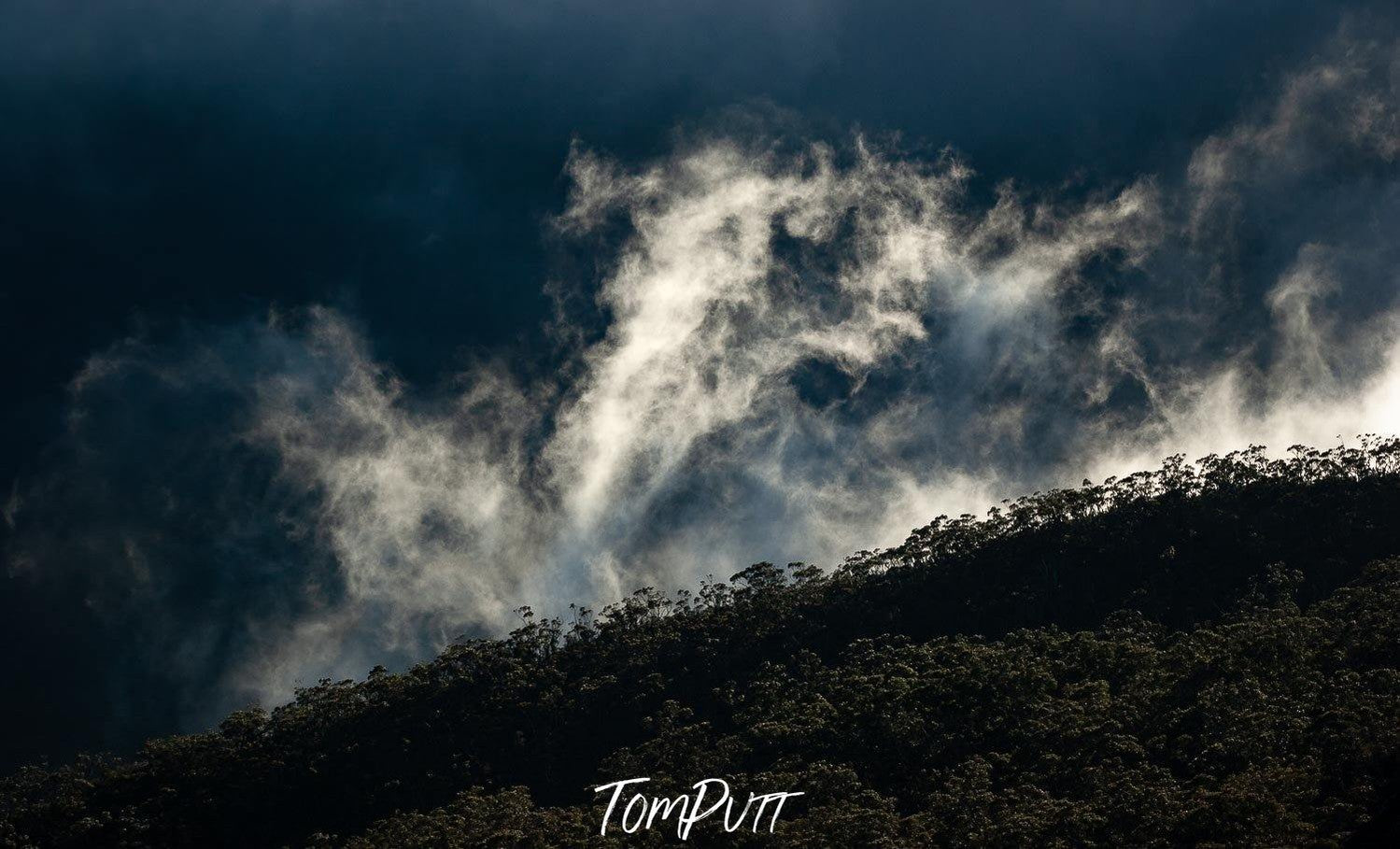 A large and dark green land with dark stormy clouds over, Rising Clouds - The Grampians, VIC