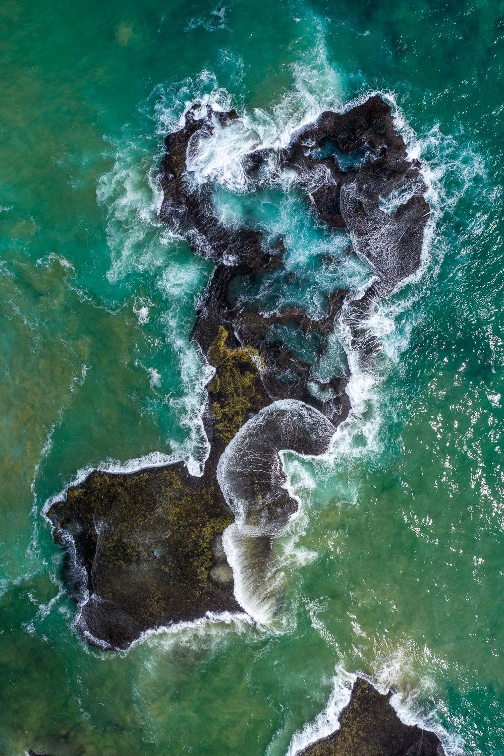 Aerial view of a wavy sea with a rocky long surface, Rock Shelf from above - Mornington Peninsula VIC