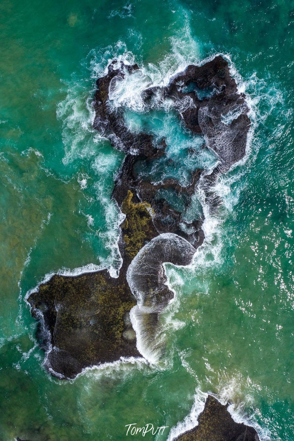 Aerial view of a wavy sea with a rocky long surface, Rock Shelf from above - Mornington Peninsula VIC