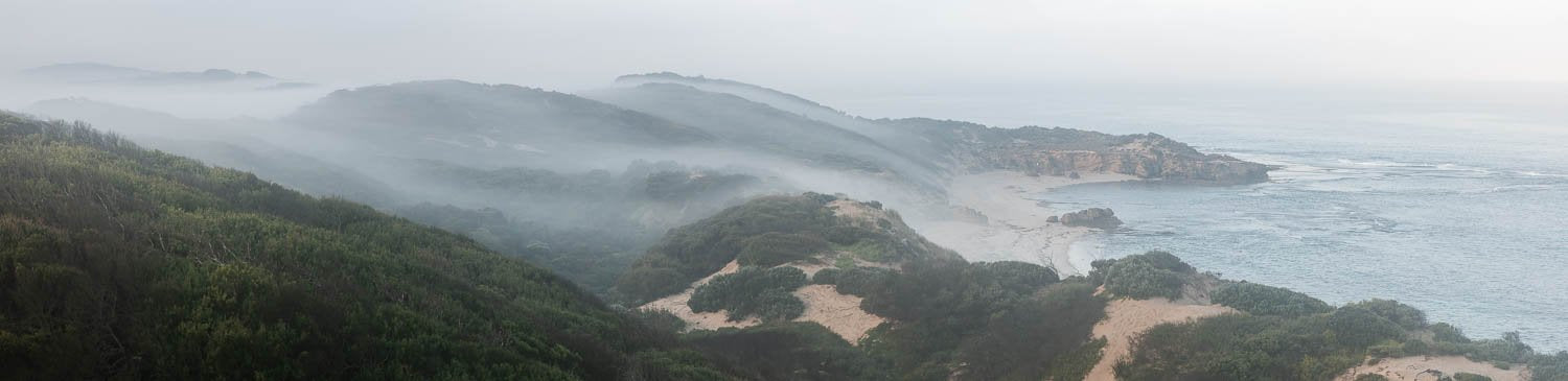 Long shot landscape of long mountain walls covered with fog, Rolling Mist, Sorrento - Mornington Peninsula