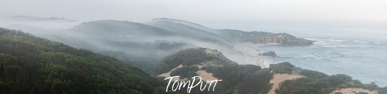 Long shot landscape of long mountain walls covered with fog, Rolling Mist, Sorrento - Mornington Peninsula