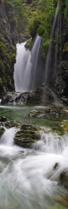 Portrait of waterfalls from a green mound in a small lake, Routeburn Falls vertical panorama, Routeburn Track - New Zealand