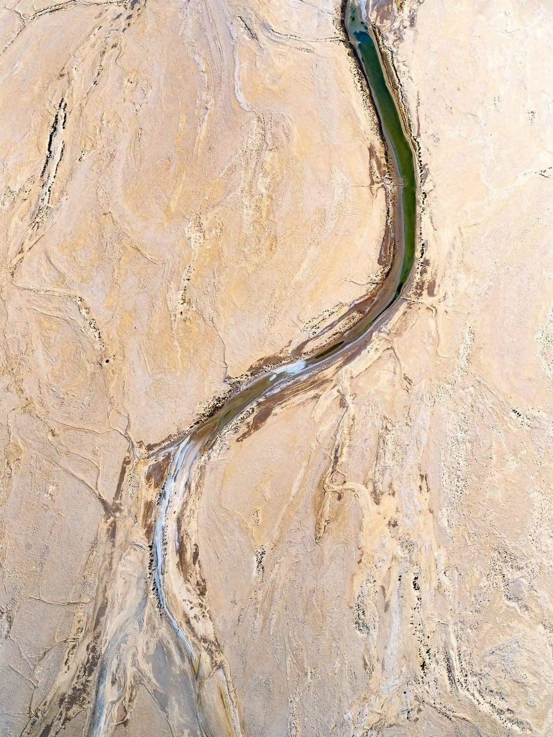 A curvy line over a solid stony surface, Running Dry
