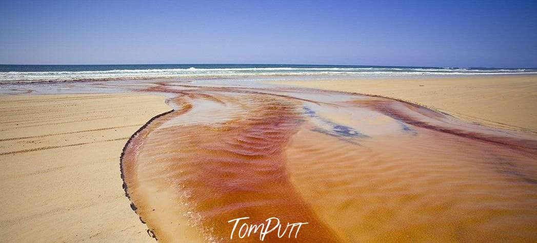 A thick brownish wavy watercourse on a beach, Sandy Creek, Fraser Island