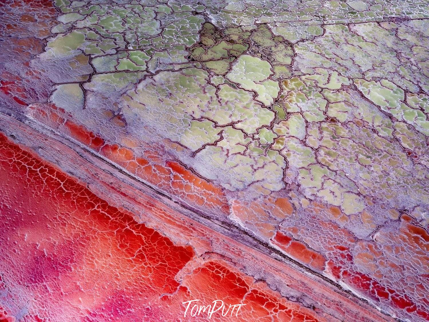 Cracked land surface with an orange line of sand, Scarlet Marble