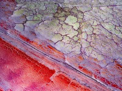 Cracked land surface with an orange line of sand, Scarlet Marble
