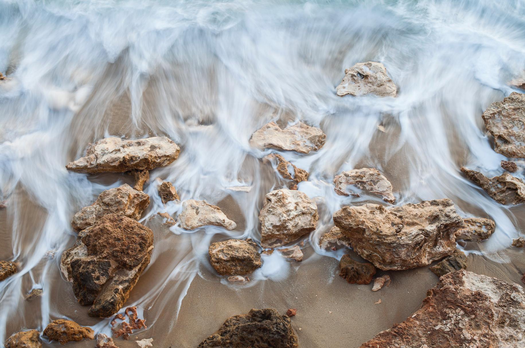 Heavy waves of water over the stones at the beach, Serenity - Mornington Peninsula VIC