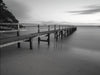 A black and white view of a wooden bridge on the seashore, Shelley Beach - Mornington Peninsula VIC