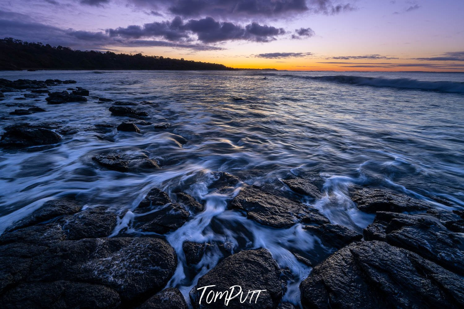 Beach with the stony surface with the flowing waves of water on the stones, and the sunset behind, Shoreham Foreshore - Mornington Peninsula VIC