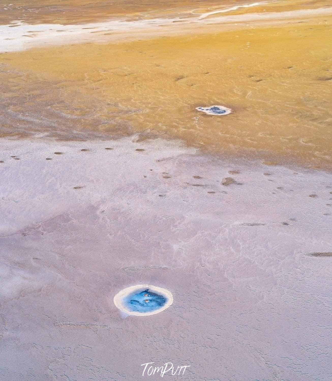 Unique small shining sky blue rounded patterns on a beach, Signs of Life