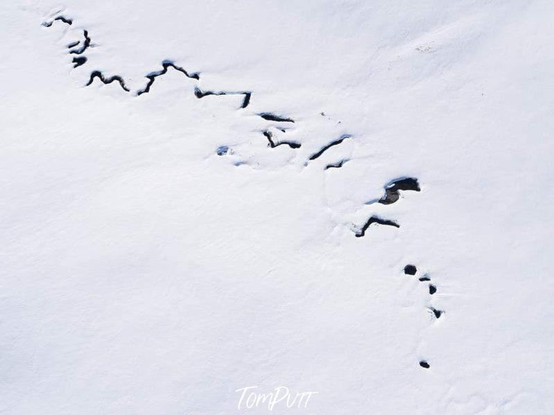 Aerial view of a snow-covered land with a cracky line, Snow Creek - Snowy Mountains NSW