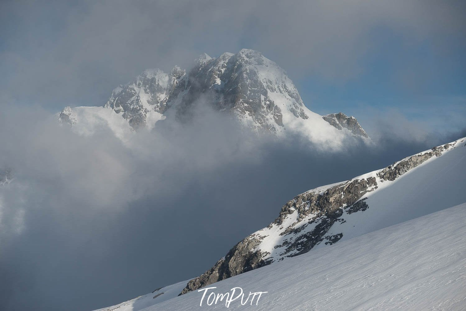 A mountain on a snow land, and a giant mountain beside partially into the clouds, New Zealand #32