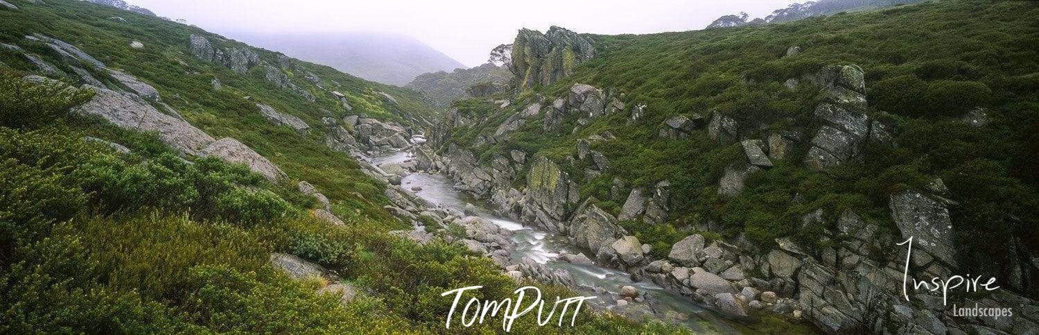 A couple of high mountains full of grass and bushes, Snowy River - Snowy Mountains NSW