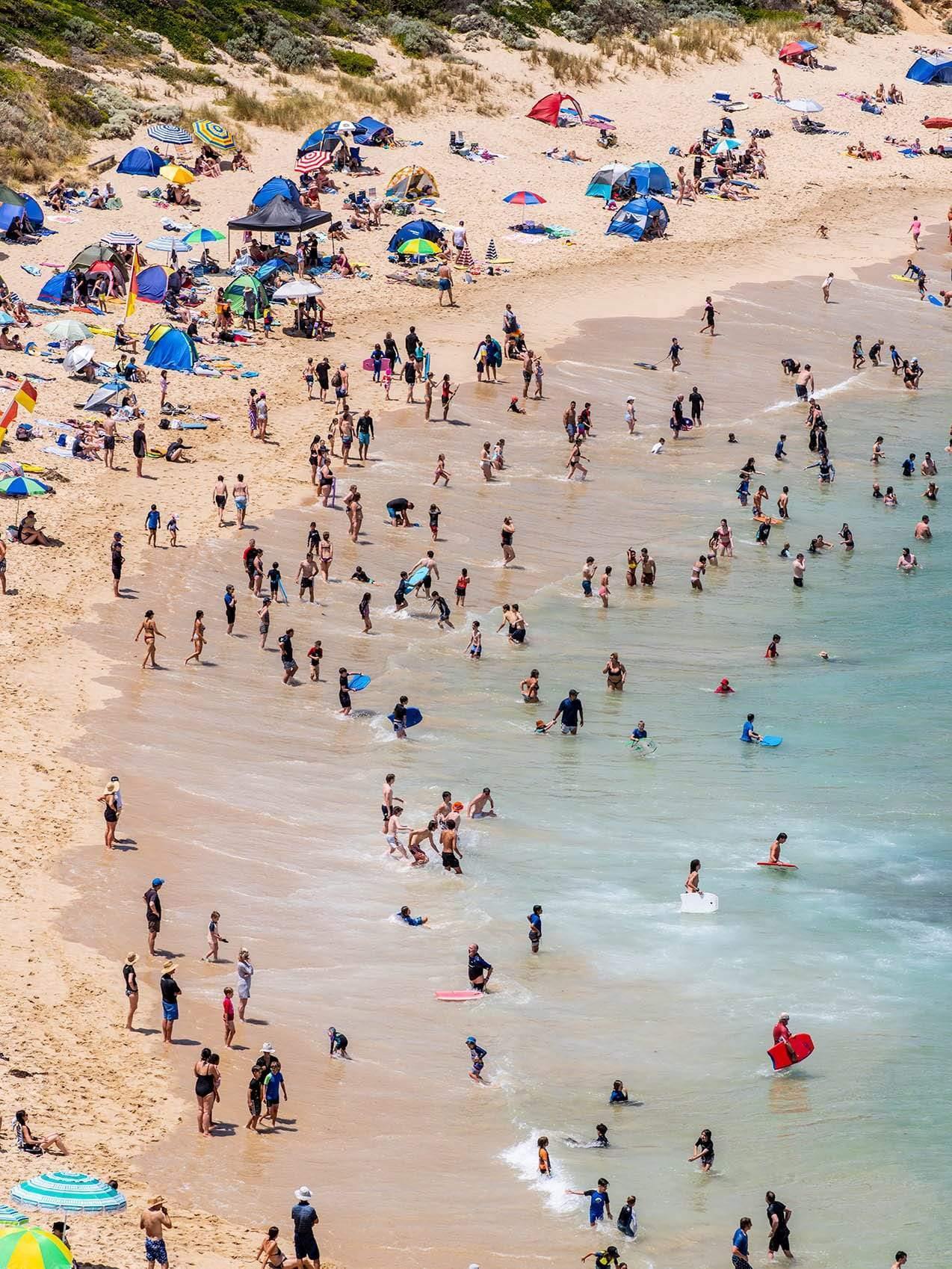 Drone view of a beach with a lot of people enjoying, Sorrento Back Beach Swimmers - Mornington Peninsula VIC
