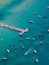Aerial view of a sea with a wooden bridge over and some boats floating over, Sorrento Couta Boat Club Jetty - Mornington Peninsula VIC