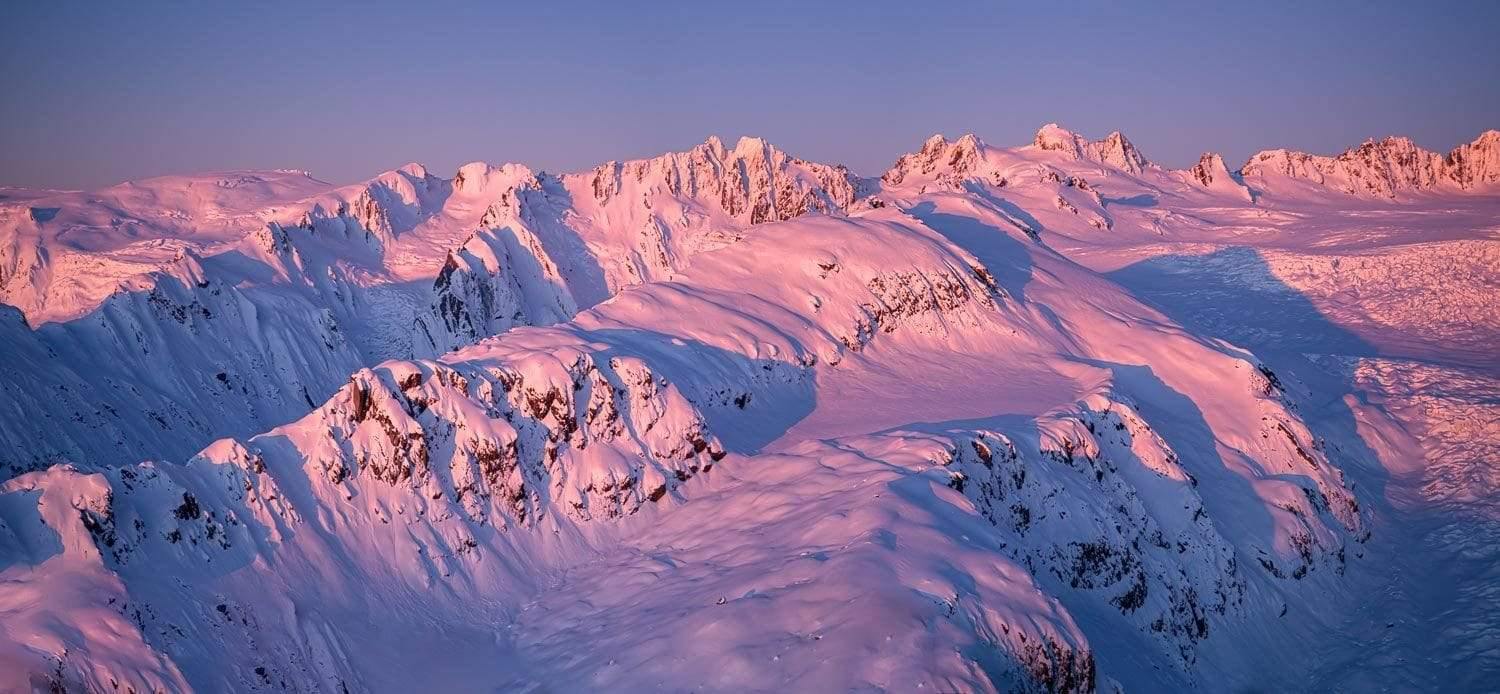 Aerial view of long mountain walls with falling sunlight covered with snow, Southern Alps Artwork