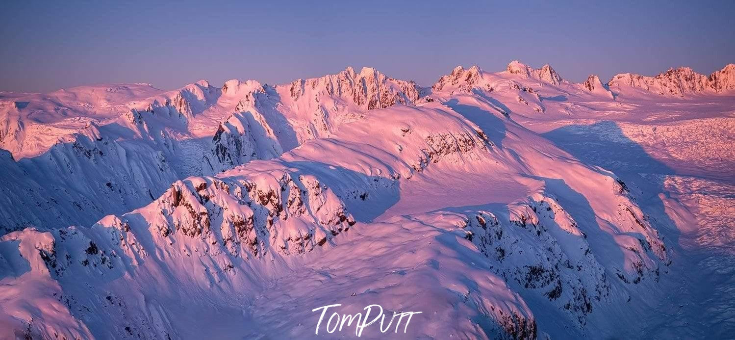 Aerial view of long mountain walls with falling sunlight covered with snow, Southern Alps Artwork