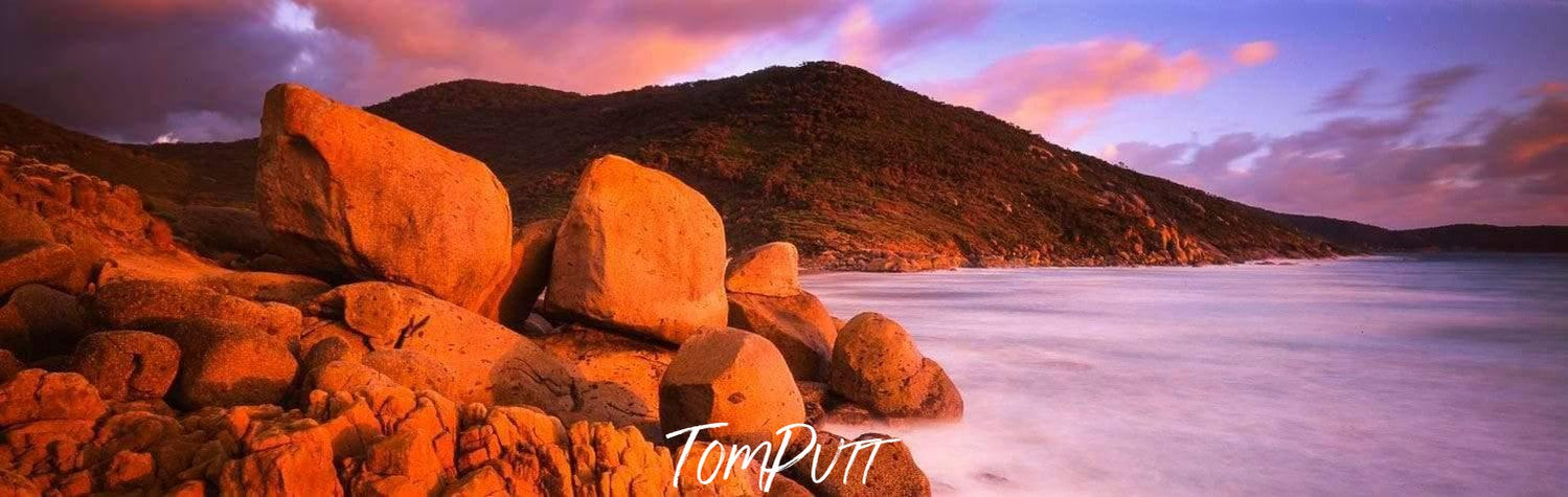 Group of orangish stones placed on a beach, Southern Tip - Wilson's Promontory VIC