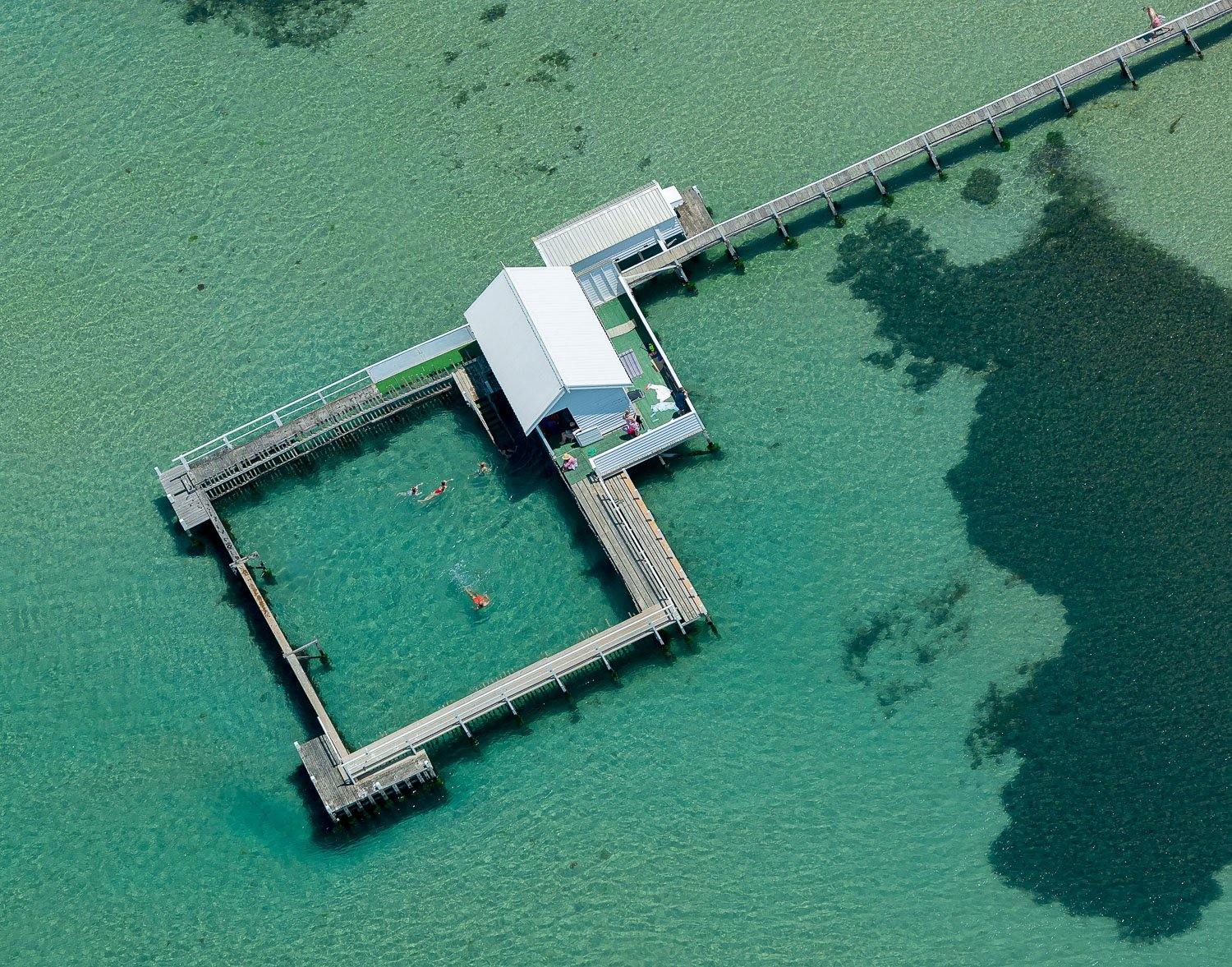 Aerial view of sea-green lake with a wooden track and a house, Square Pool, Portsea - Mornington Peninsula VIC