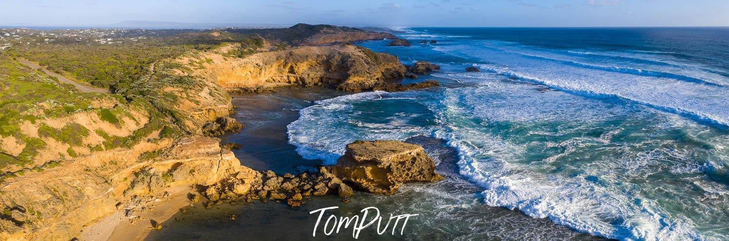 Aerial view of a seashore with a long flat mountain wall, St Paul's Aerial Sorrento - Mornington Peninsula VIC