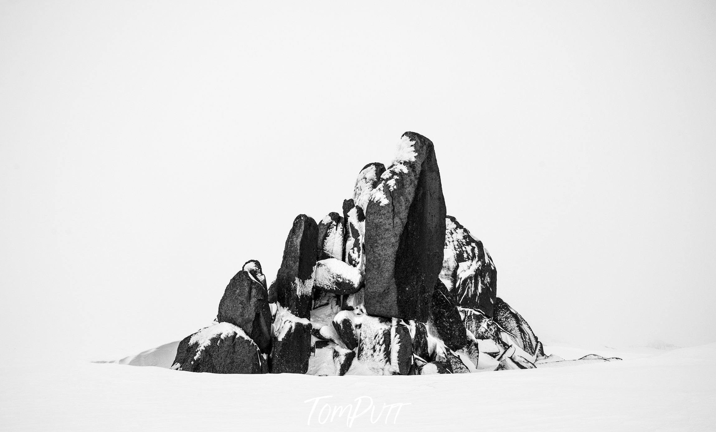 A dark rocky mountain partially covered with snow, Standing Firm - Snowy Mountains NSW