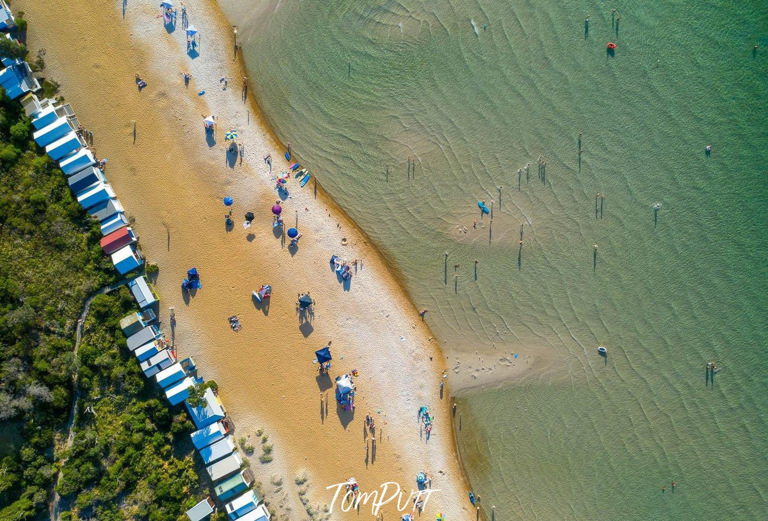 Aerial view of a calm beach with some people and colorful huts outside, Summer Bathers Mt Martha - Mornington Peninsula VIC