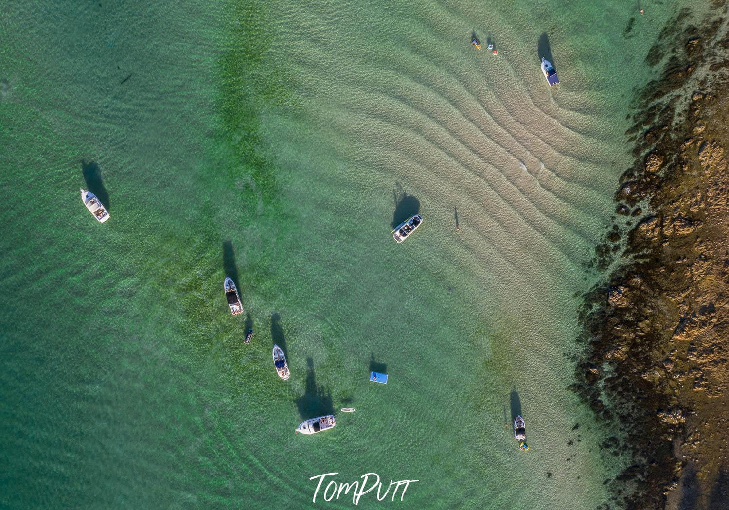 Aerial view of a calm sea with some boats over and a big mountain wall on the corner, Summer Ripples, Mt Martha - Mornington Peninsula VIC