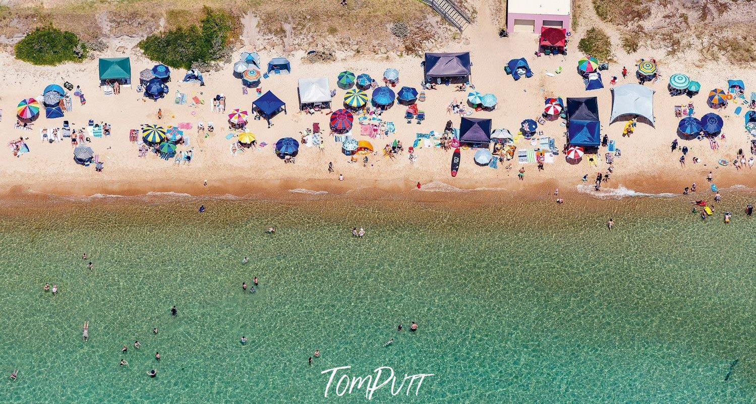 Aerial view of a beautiful green beach with many people and huts, Summer Solstice - Mornington Peninsula VIC