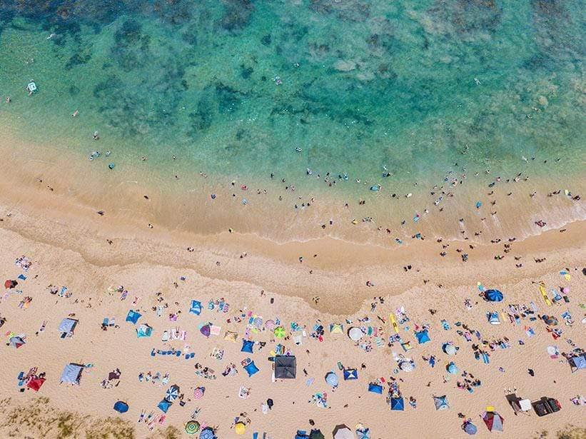 Aerial of a green water beach with a lot of people, Summer at Sorrento - Mornington Peninsula VIC