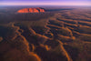 A giant texture of mound waves in the desert, Sunrise over Uluru from the air - Northern Territory