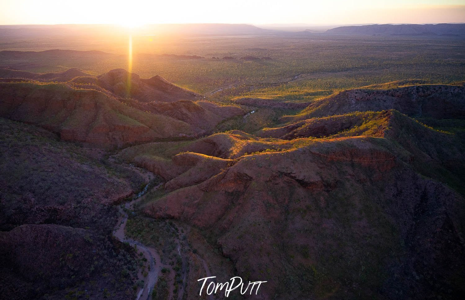 Huge rocky mountain lines with a sunset burst