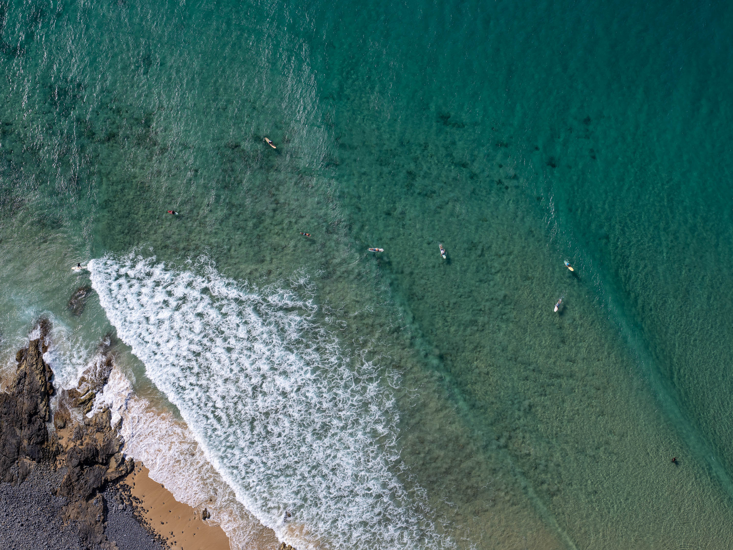 Aerial view of a seashore with giant bubbling waves on the corner, Surfers from above #4, Noosa National Park, Queensland