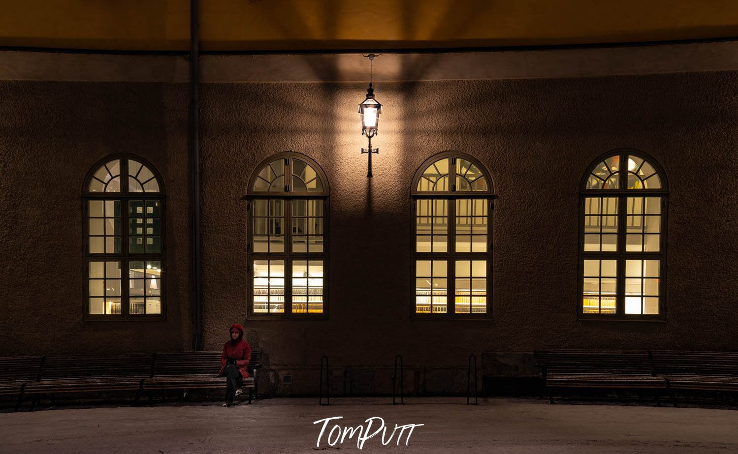 A shadowy capture of a big hall with a men sitting on a bench, Sweden No.13