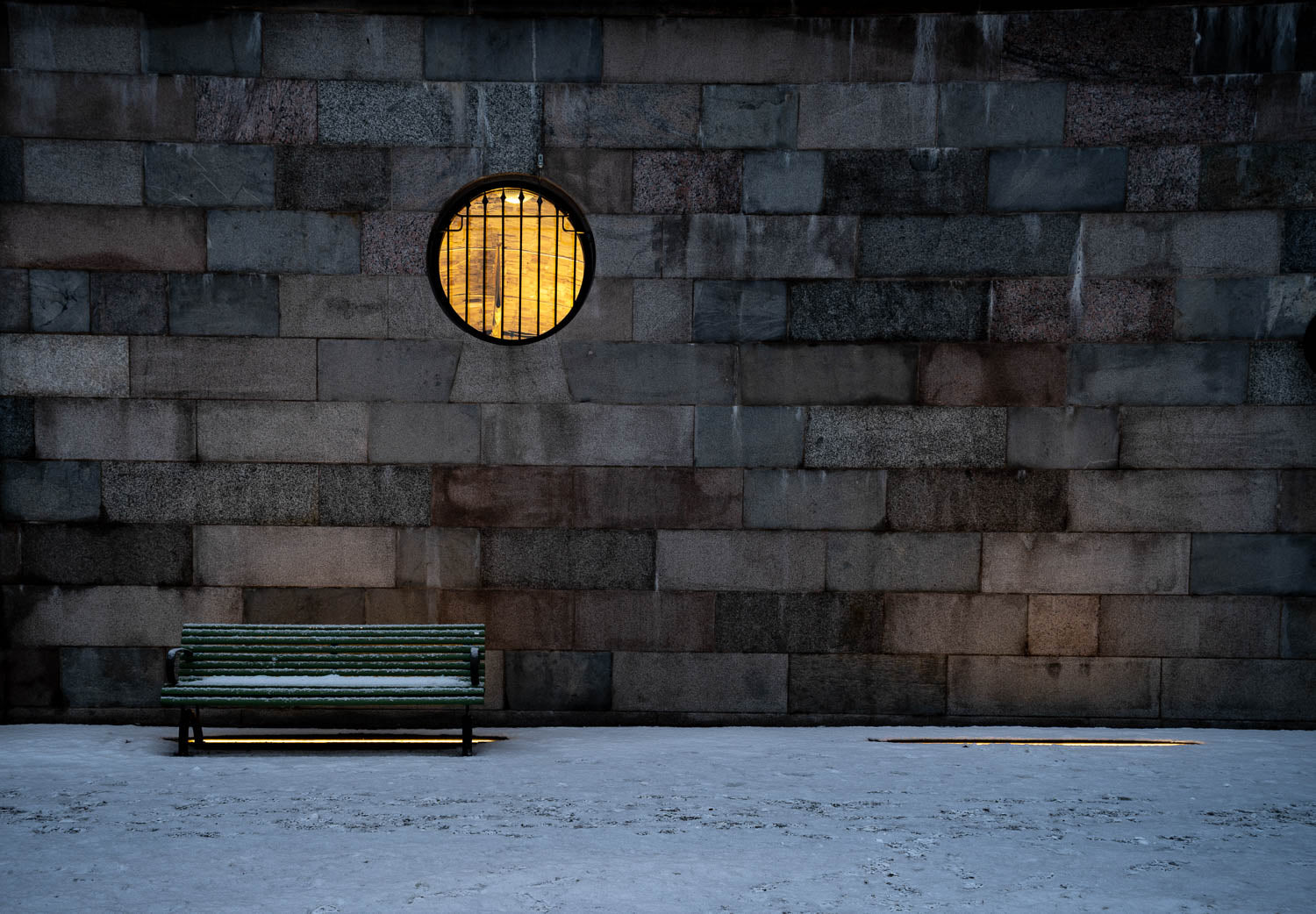 A bricked wall with a bench placed on the ground, Sweden #17