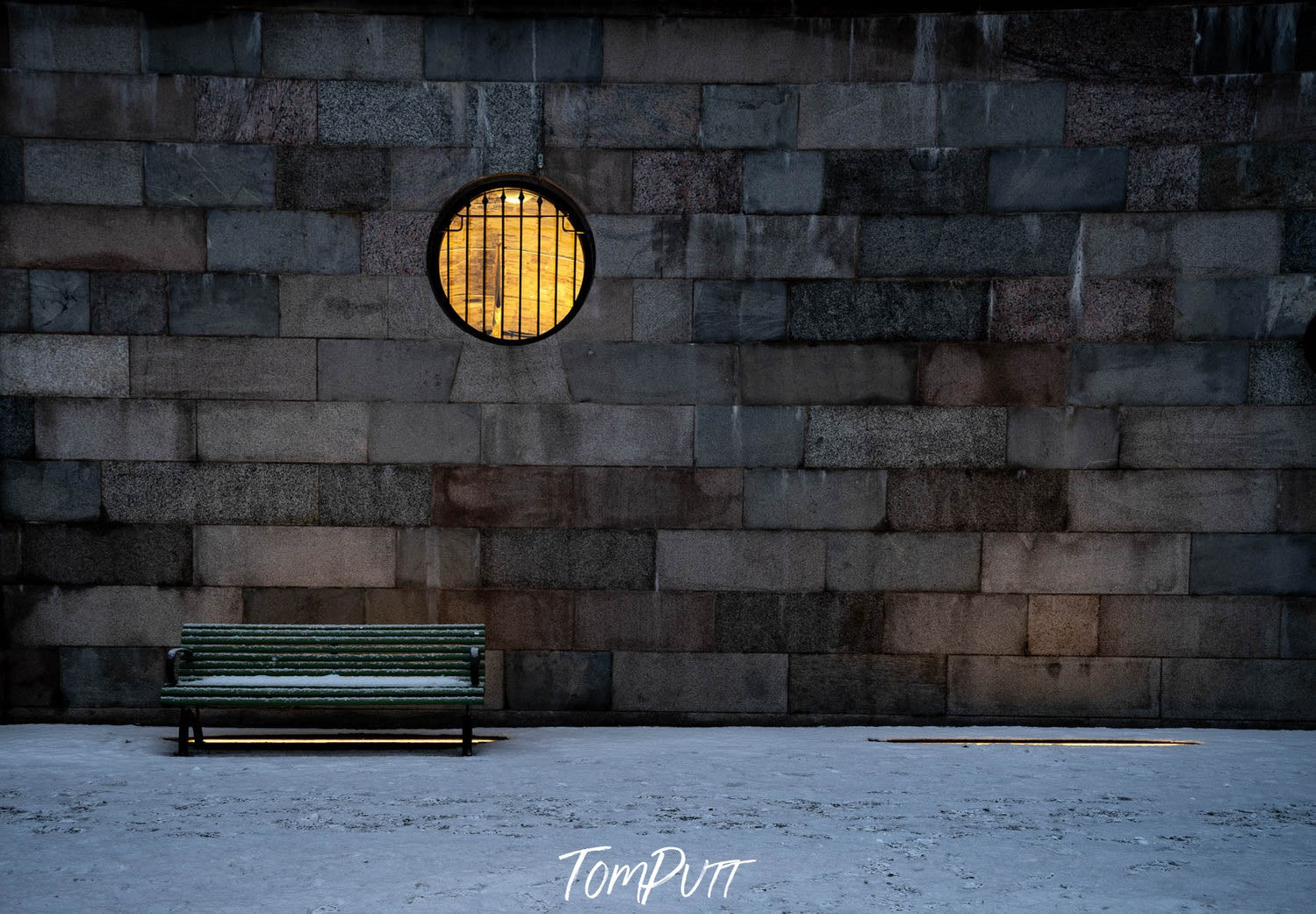 A bricked wall with a bench placed on the ground, Sweden No.17