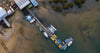 Aerial view of a wooden bridge over the lake, with many boats, rides ready to go, Take Your Pick, Warneet - Mornington Peninsula VIC