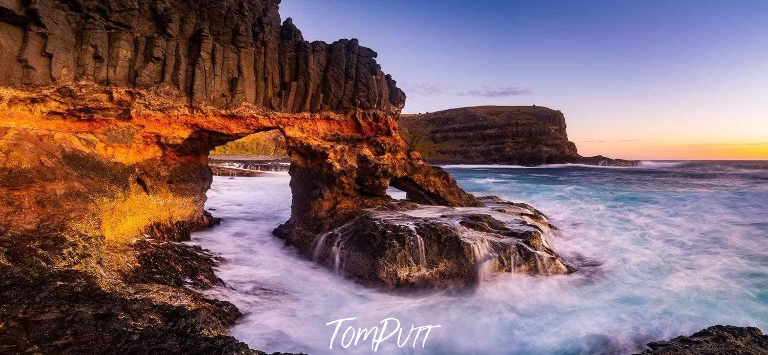 Big standing stones in the sea with a giant mountain wall on the shore, The Archway, Bushrangers Bay - Mornington Peninsula VIC