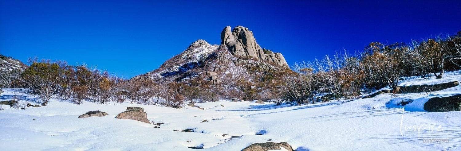A mound of rocks with a snow-covered area below, Mount Buffalo - Victorian High Country