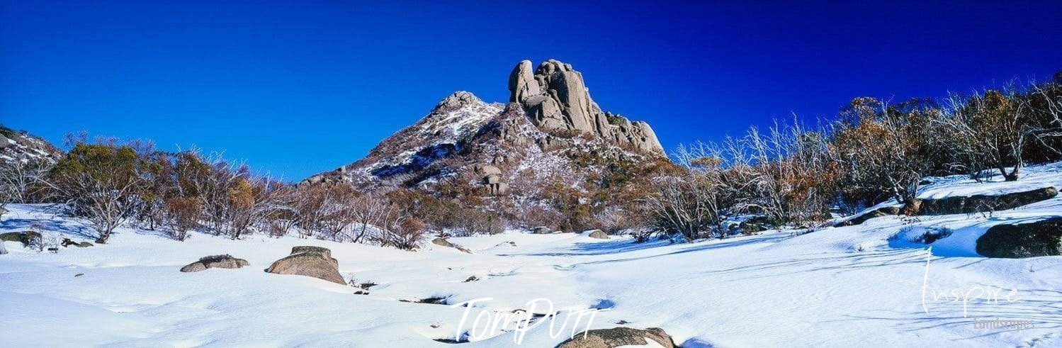 A mound of rocks with a snow-covered area below, Mount Buffalo - Victorian High Country