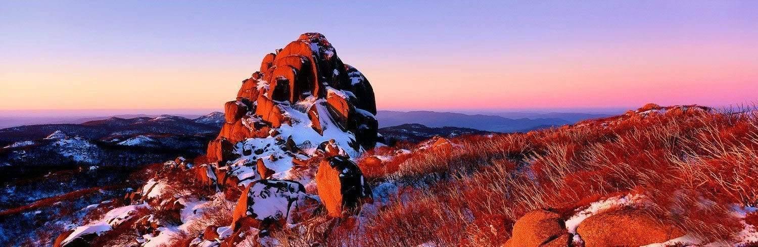 Unique design of a high mountain rock with orange and snow colors, The Cathedral - Mount Buffalo VIC
