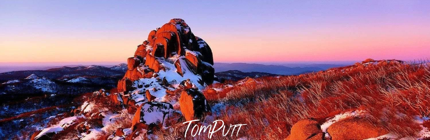 Unique design of a high mountain rock with orange and snow colors, The Cathedral - Mount Buffalo VIC