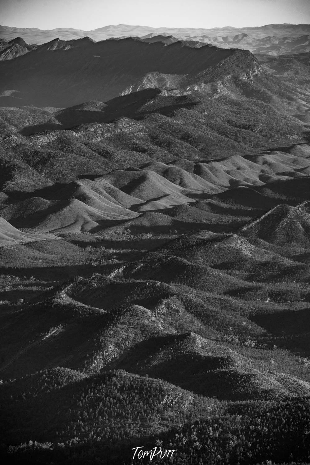 A lot of stony mounds on on black surface, The Crocodile-like appearance of the Flinders Ranges, SA